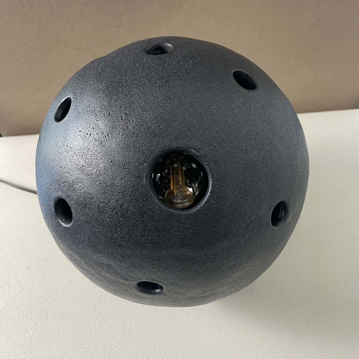 vue de côté lampe effet granit noir